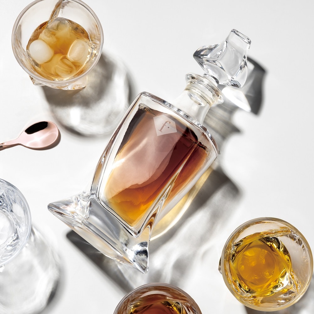 Whiskyszett 4 pohárral és üvegdekanterrel. Az üvegkancsó és poharai felülnézetből.